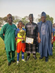 945263cf-7637-48e0-b7f7-894aa2099c7b-225x300 Mogaji Rewards Player of the Match, Celebrates Bako’s Retirement at U-13 Tournament